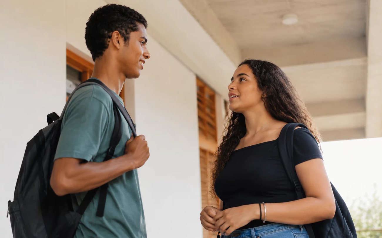 Grupo pequeno lendo folhas de argumentos em volta de uma mesa comprida